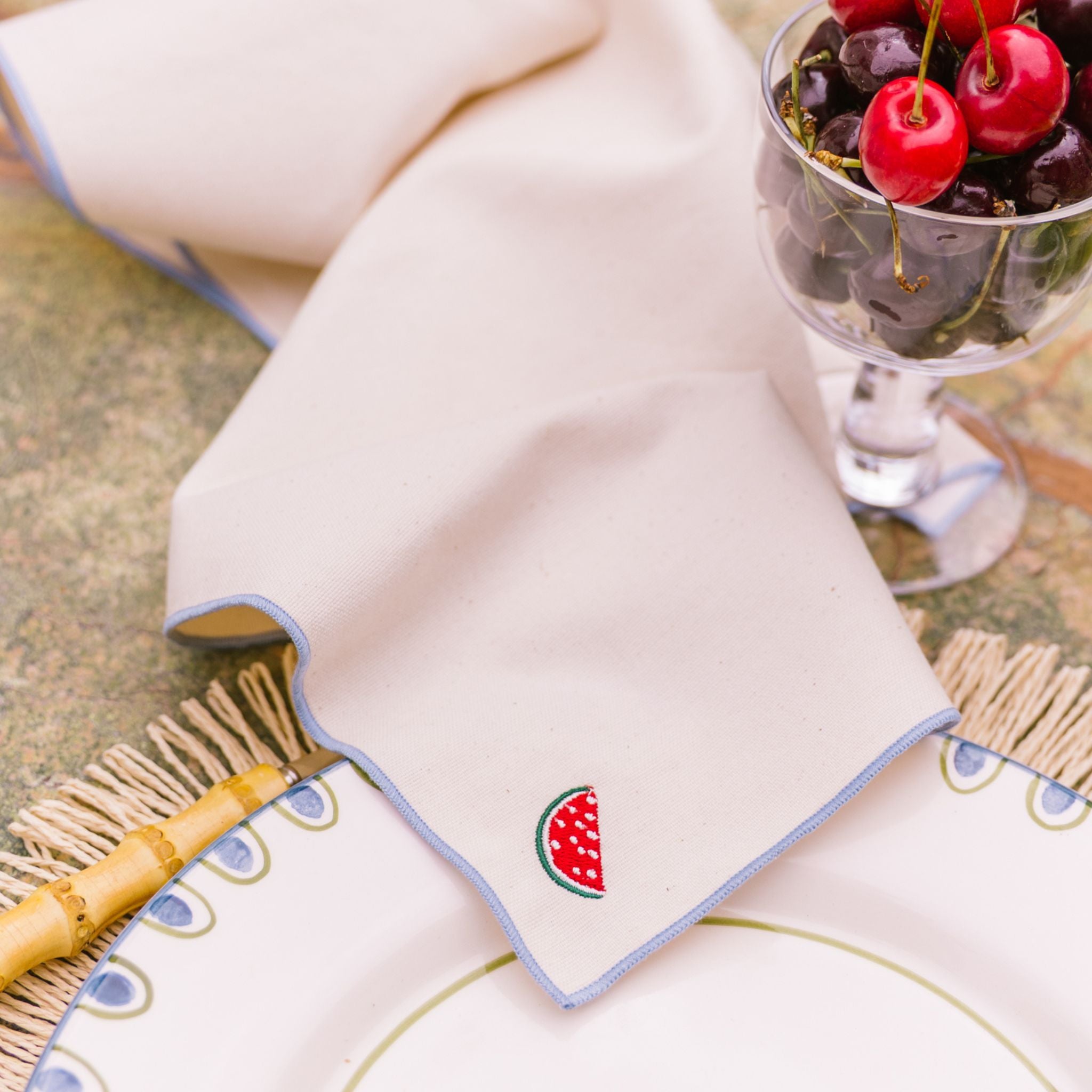 torres-novas-table-nazare-embroidery-fruits-ecru-napkin-blue-sky-lifestyle.jpg