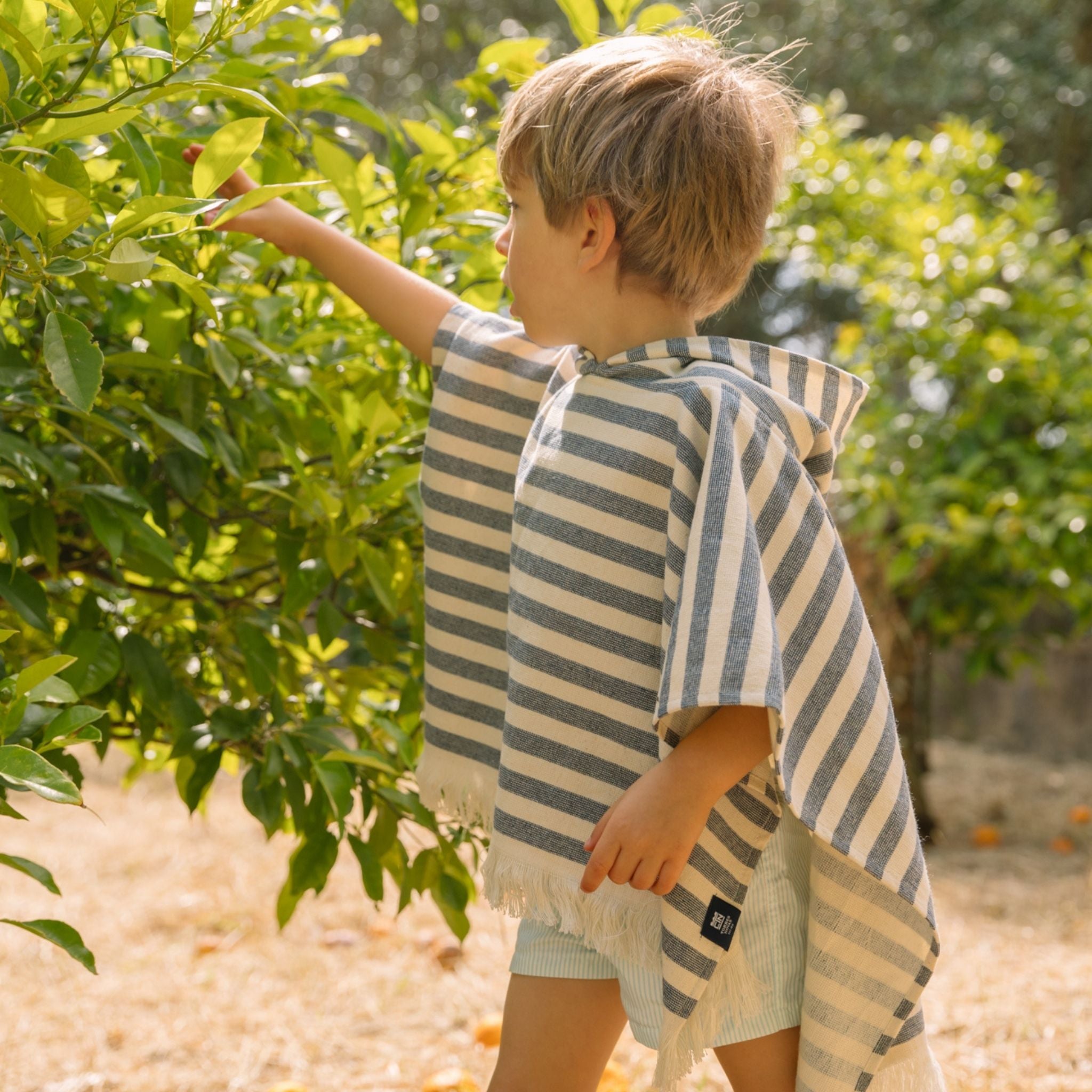 torres-novas-beach-barra-horizontal-stripes-baby-poncho-blue-lifestyle-4.jpg